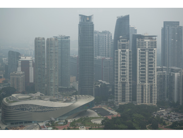 High-rise buildings are seen in Kuala Lumpur on October 20, 2026, as Malaysia continues to be shrouded in haze. (Photo by Mohd Rasfan / AFP)