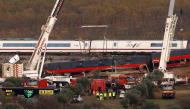 Huge cranes are employed to remove wrecked carriages of a train crash between a Renfe AVE train and an Iryo train, one day after the deadly accident in Urda, in the province of Toledo on October 29, 2026. Photo by OSCAR DEL POZO / AFP