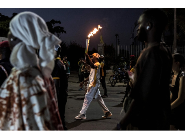 A torchbearer carries the Youth Olympic Flame on the eve of the opening ceremony of the Youth Olympic Games in Dakar on October 30, 2026. (Photo by Patrick Meinhardt / AFP)