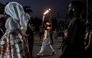 A torchbearer carries the Youth Olympic Flame on the eve of the opening ceremony of the Youth Olympic Games in Dakar on October 30, 2026. (Photo by Patrick Meinhardt / AFP)
