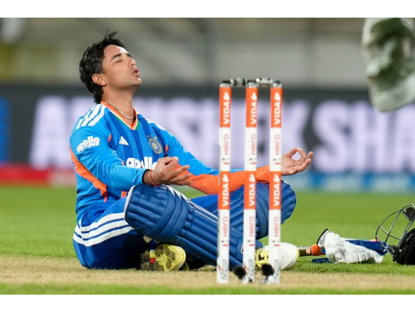 India's Abhishek Sharma celebrates after reaching his century in Wellington on October 27, 2026. (Photo by Marty Melville / AFP)