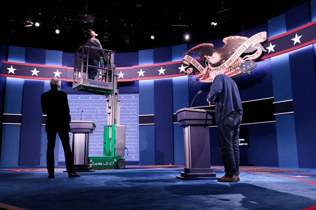 Workers make adjustments to the set for the first U.S. presidential debate at Hofstra University on September 25, 2016 in Hempstead, New York. Democratic presidential candidate Hillary Clinton is scheduled to debate Republican presidential candidate Donal