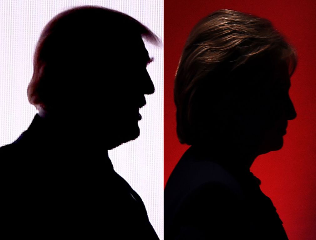 This combination of file photos shows the silhouettes of Republican presidential nominee Donald Trump(R)July 18, 2016 and Democratic presidential nominee Hillary Clinton on February 4, 2016. AFP / DESK