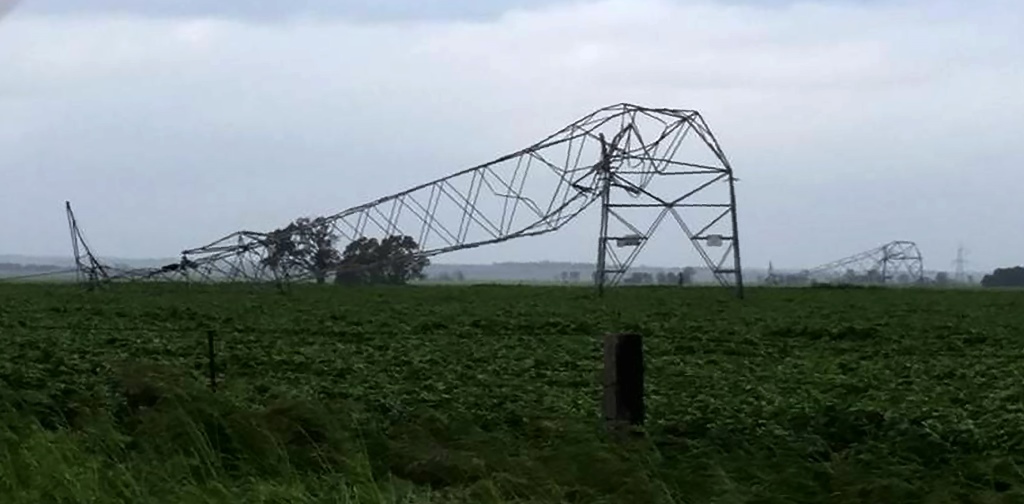 A photo taken on September 28 and obtained on September 29, 2016, shows transmission towers carrying power lines, toppled by high winds near Melrose in South Australia. Australia on Thursday after 