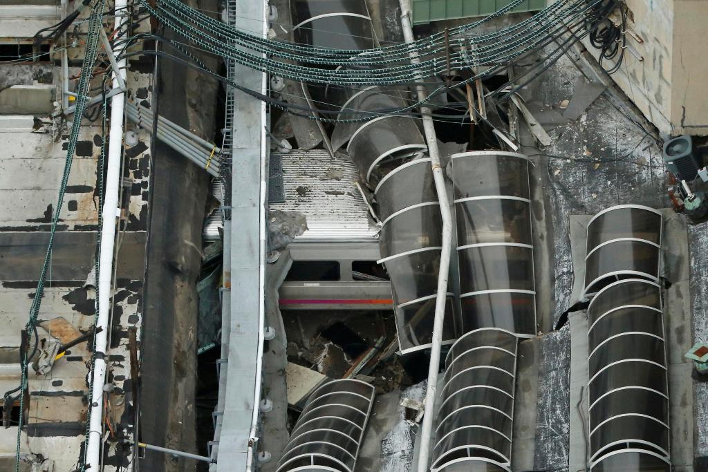A derailed New Jersey Transit train is seen under a collapsed roof after it derailed and crashed into the station in Hoboken, New Jersey, U.S. September 29, 2016. (REUTERS/Carlo Allegri)