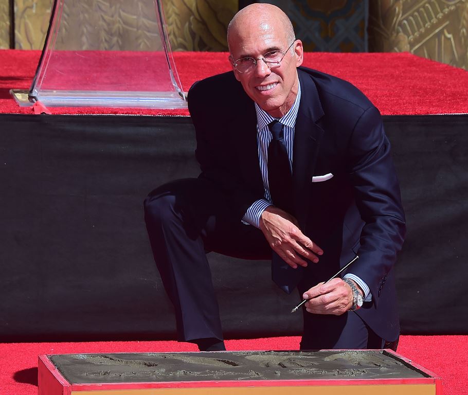 Hollywood producer Jeffrey Katzenberg looks up while writing in the block of cement during his Hand and Footprints ceremony in front of the TCL Chinese Theater in Hollywood, California in September 29, 2016. AFP / FREDERIC J BROWN