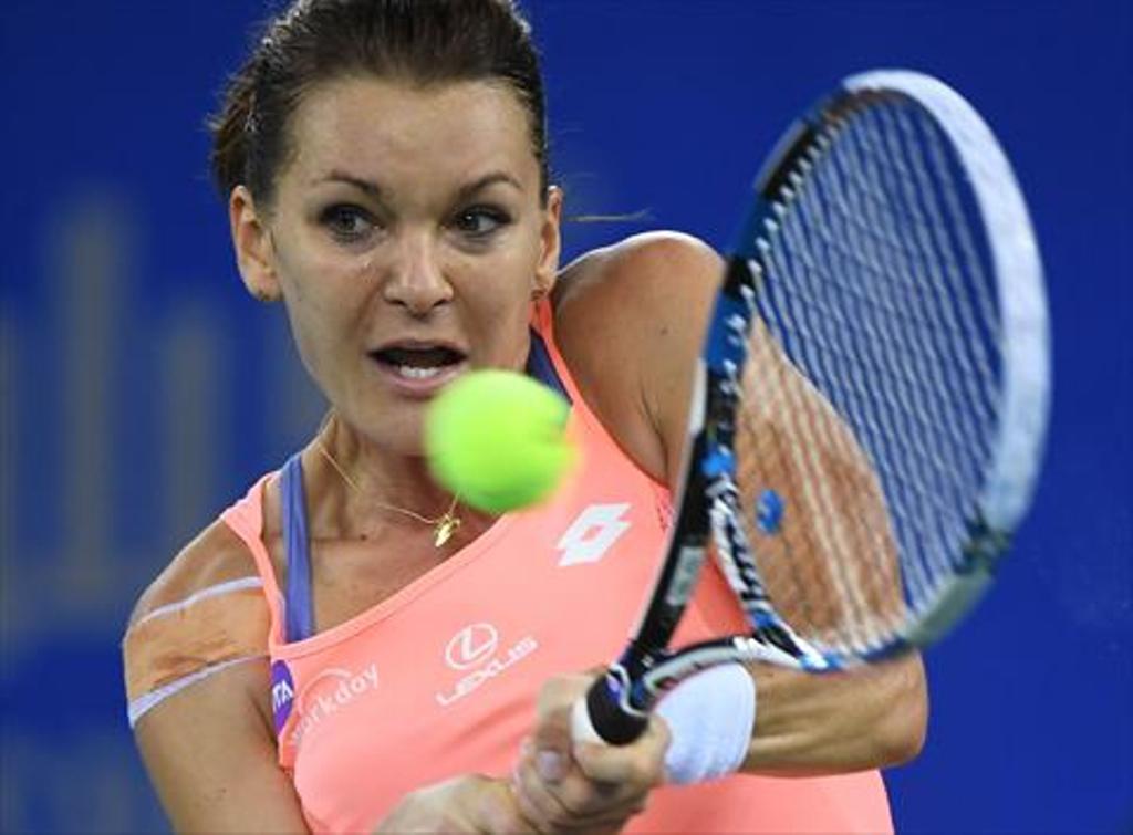 Agnieszka Radwanska of Poland hits a return during her quarter-final match against Svetlana Kuznetsova of Russia at the WTA Wuhan Open tennis tournament in Wuhan, in China's central Hubei province on September 29, 2016. / AFP / GREG BAKER