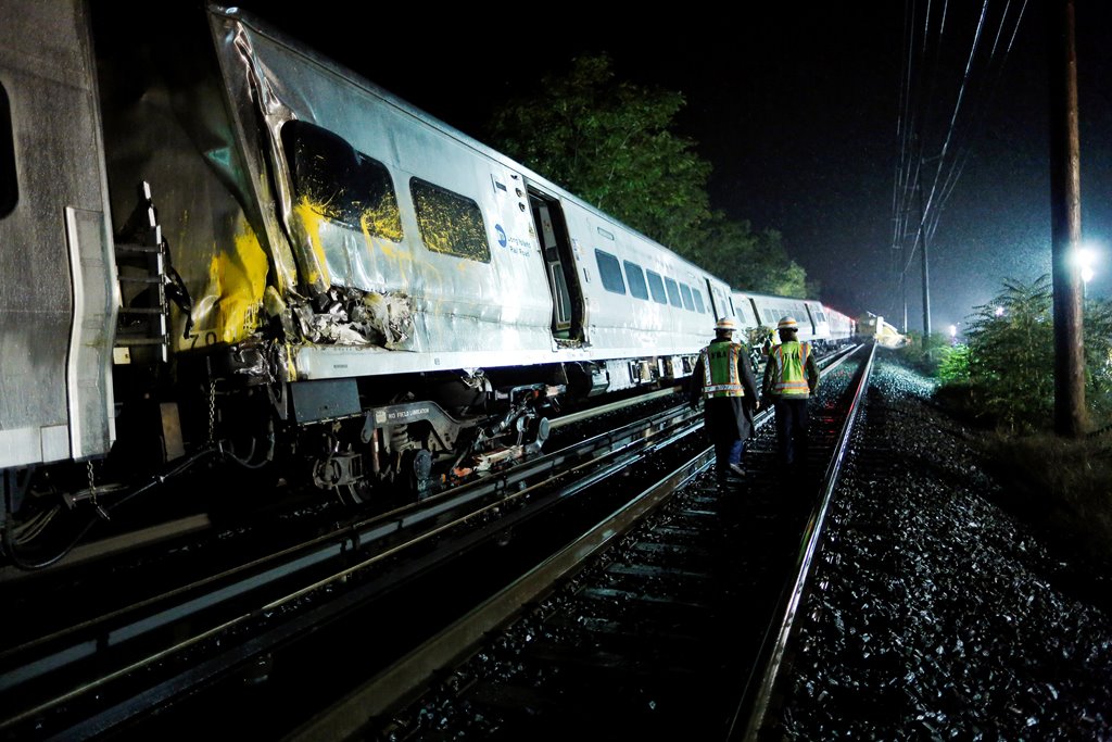 Emergency responders work near a train that sits derailed near the community of New Hyde Park on Long Island in New York, US, October 9, 2016. Reuters/Eduardo Munoz
