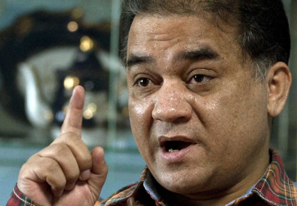 Outspoken scholar of China's Uighur minority, Ilham Tohti, shown here in 2013, gestures as he speaks during an interview at his home in Beijing, China. (Andy Wong/AP)
