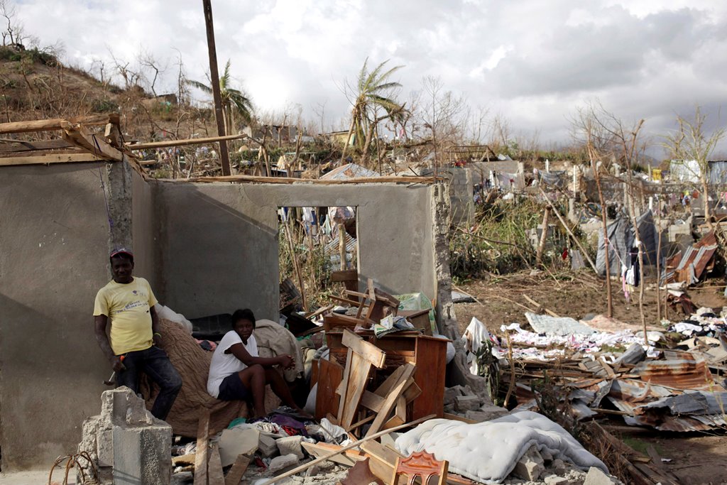 A couple sitting on the rubble that was once their home. Reuters 