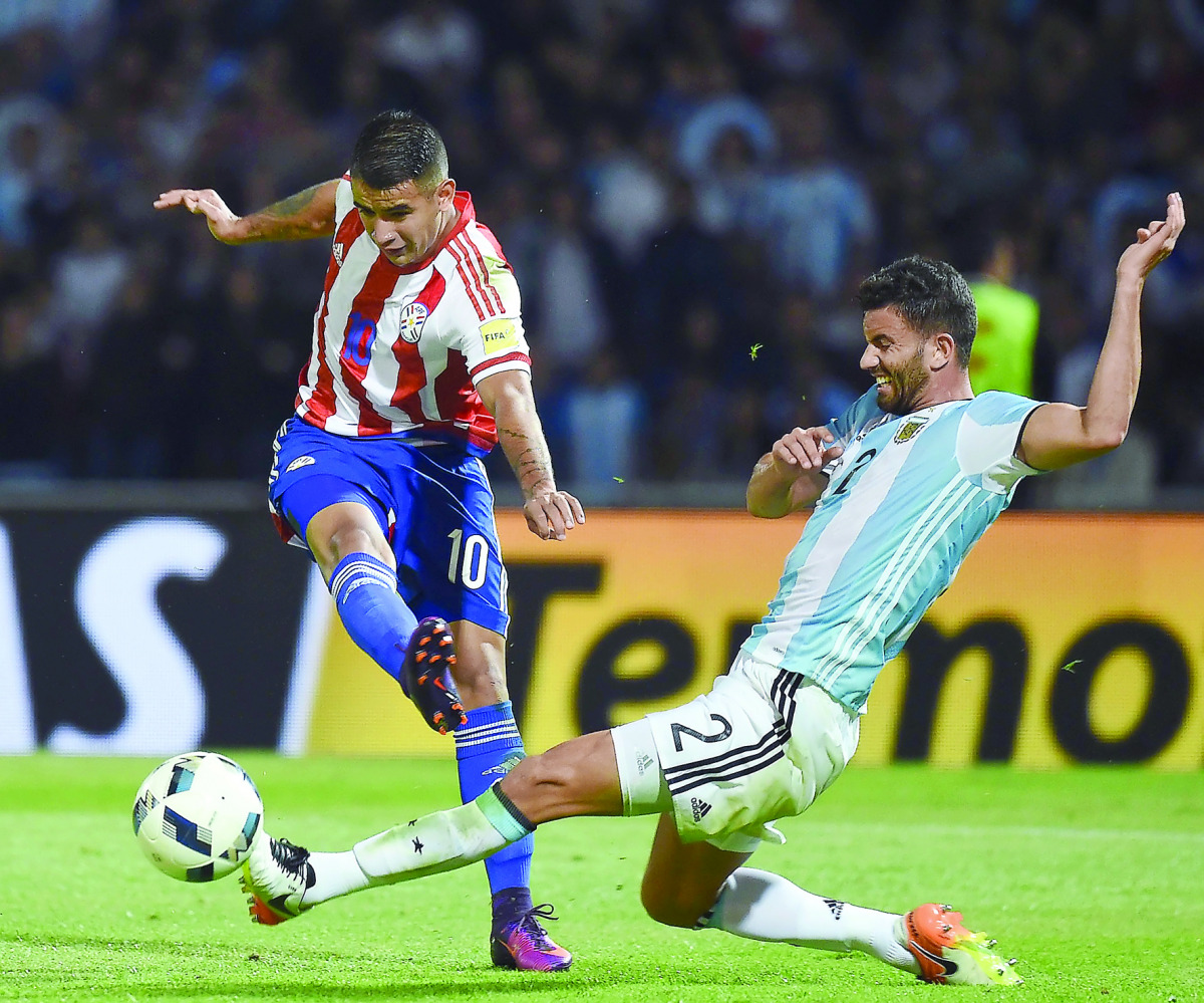 Paraguay’s Derlis Gonzalez (left) vies for the ball with Argentina’s Mateo Mussacchio  during their Russia 2018 World Cup qualifier football match at Alberto Kempes Stadium in  Cordoba, Argentina, on Tuesday.