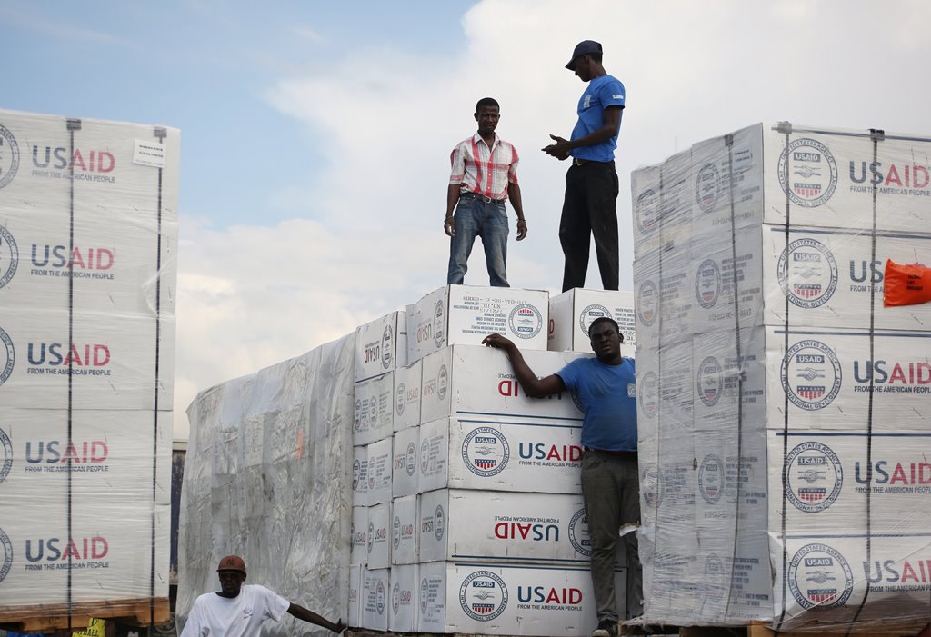 Workers load relief aid sent by the US onto a truck after Hurricane Matthew passed, in Port-au-Prince, Haiti, October 12, 2016. REUTERS/Jeanty Junior Augustin 