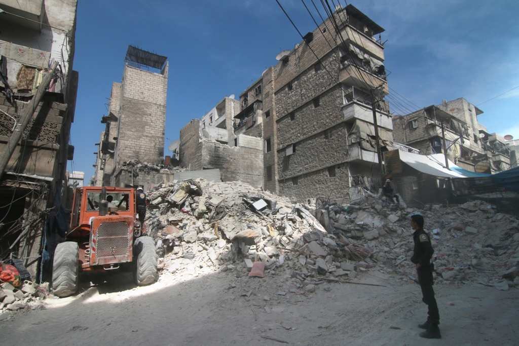 Collapsed buildings are seen after the war crafts belonging to the Russian Army carried out airstrike on a residential area in Aleppo, Syria on October 12, 2016. ( Jawad al Rifai - Anadolu Agency )