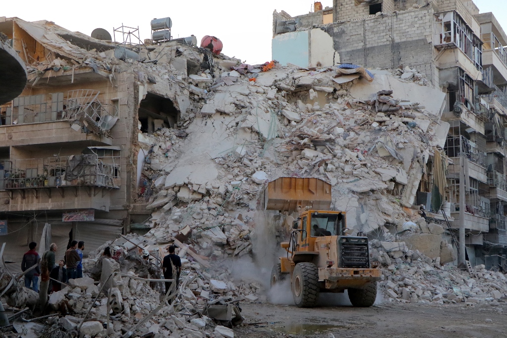 Syrians inspect the debris of collapsed buildings after airstrike over residential areas at opposition controlled Merce neighborhood in Aleppo, Syria on October 17, 2016. (?brahim Ebu Leys - Anadolu Agency)