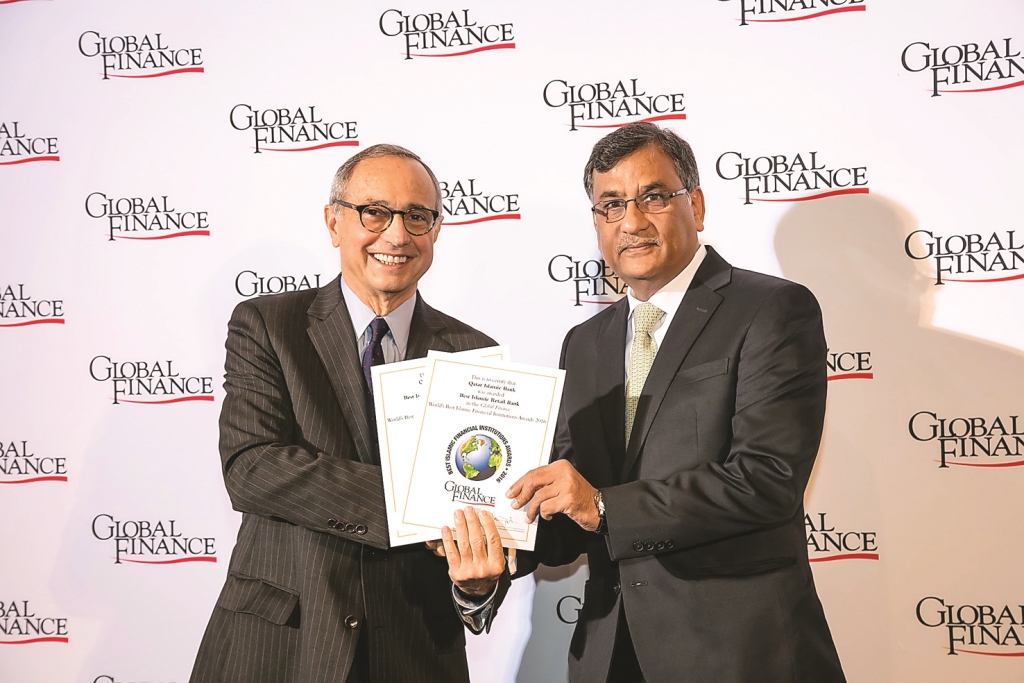 Ali Khan (right), Head of Financial Institutions, receiving the award on behalf of QIB. 