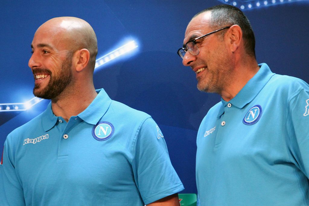 Napoli's Italian head coach Maurizio Sarri (R) and Napoli's Spanish goalkeeper Pepe Reina smile during a press conference at the SSC Napoli headquarters on October 18, 2016, on the eve of the UEFA Champions League Group B football match SSC Napoli vs Besi