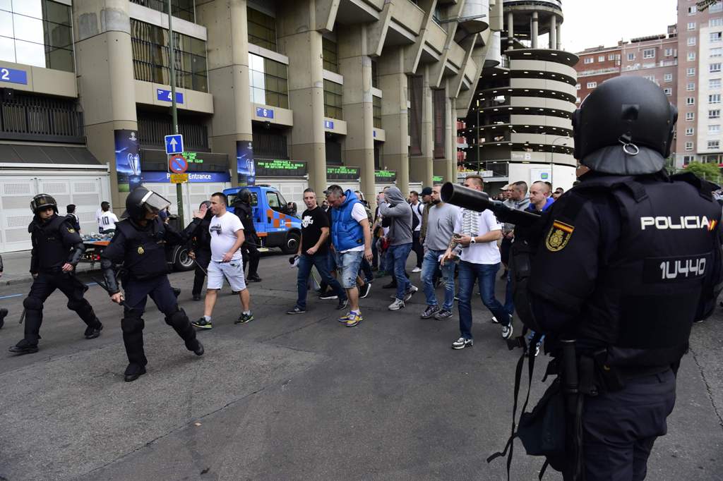 Legia Warsaw football fans are escorted by Spanish poilce into the stadium to take their seats ahead of the UEFA Champions League football match Real Madrid CF vs Legia Legia Warszawa at the Santiago Bernabeu stadium in Madrid on October 18, 2016.   AFP /
