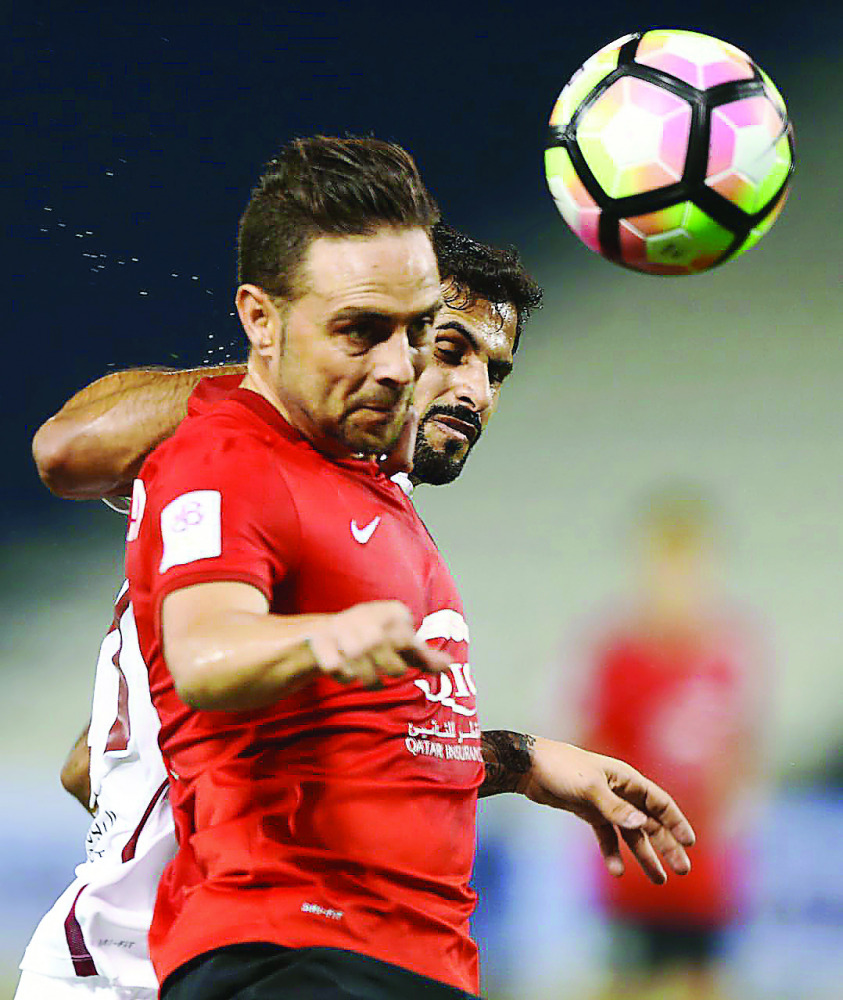 Al Rayyan’s Spanish striker Sergio Garcia (front) heads the ball during their Qatar Stas League match against El Jaish at Al Sadd Stadium. 