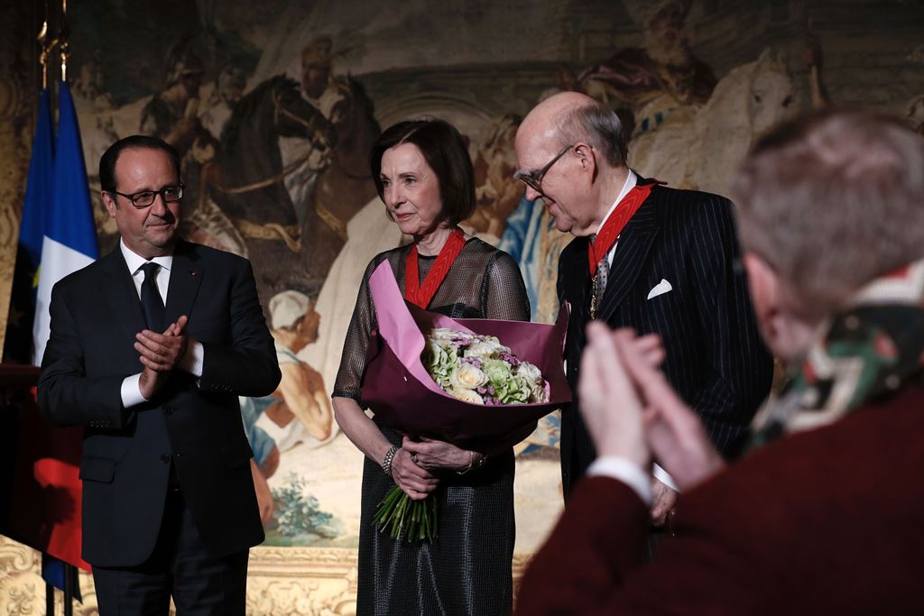American collectors Marlene (C) and Spencer (R) Hays pose for a photograph after they have been awarded Chevalier de la Legion d'Honneur (Knight of the Legion of Honour) by French President Francois Hollande (L) following their donation of painting master