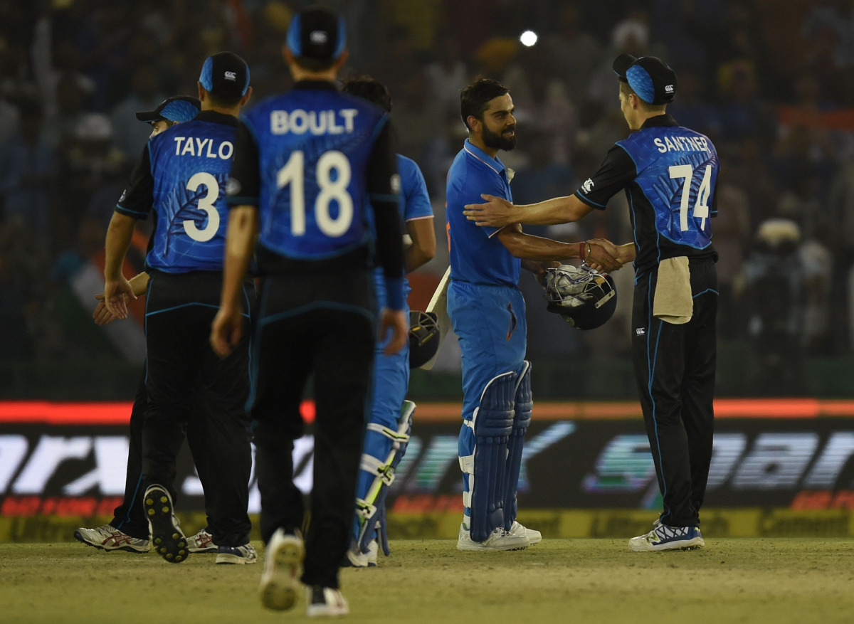 India's Virat Kohli (C) is congratulated by members of the New Zealand cricket team after India won the third one day international (ODI) match between Indian and New Zealand at The Punjab Cricket Stadium Association Stadium in Mohali on October 23, 2016.