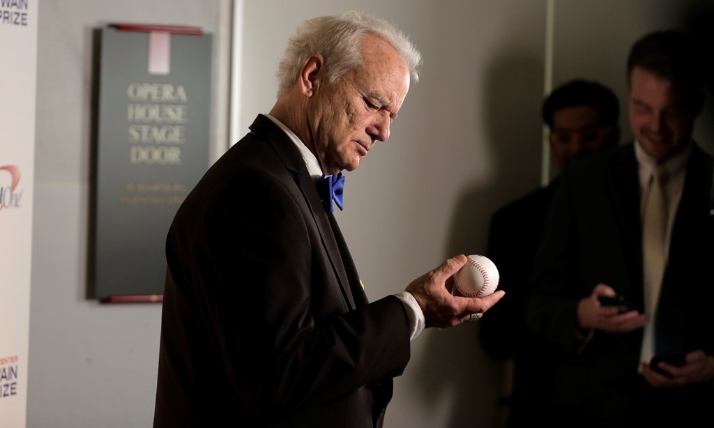 Actor, comedian and Chicago Cubs fan Bill Murray look at a baseball as he arrives to receive the 19th annual Mark Twain Prize for American Humor at the Kennedy Center in Washington, U.S., October 23, 2016. Reuters/Joshua Roberts