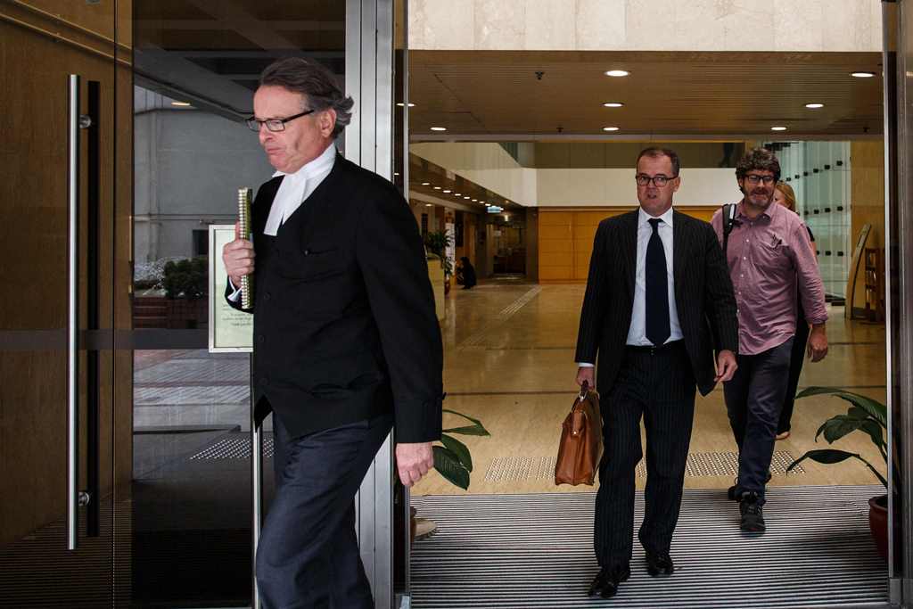 Barrister Tim Owen (L) and lawyer Michael Vidler (C), defending former British banker Rurik Jutting (not seen), 31, who is accused of the murders of two Indonesian women, leave the High Court during a break for lunch in Hong Kong on October 24, 2016, on t