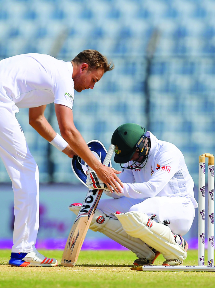 England’s Stuart Broad (left) consoles Bangladesh’s not-out batsman Sabbir Rahman after England took the final wicket to win the first Test match on the final day’s play at Zahur Ahmed Chowdhury Cricket Stadium in Chittagong, yesterday.