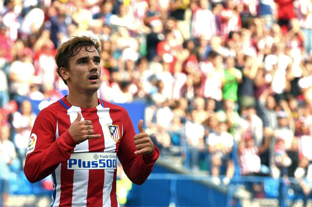 (FILES) This file photo taken on September 17, 2016 shows Atletico Madrid's French forward Antoine Griezmann celebrating after scoring during the Spanish league football match Club Atletico de Madrid vs Real Sporting de Gijon at the Vicente Calderon stadi