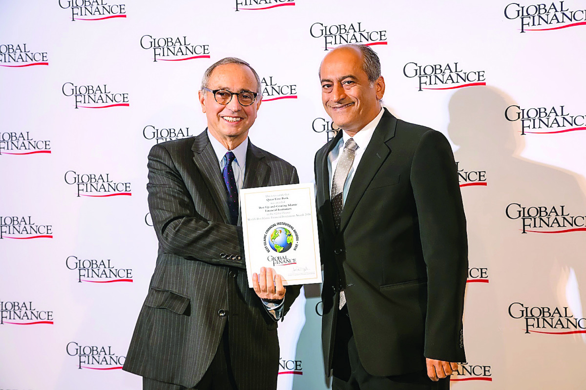 Sulaiman Yousif Al Salhi (right) breceiving the award on behalf of QFB. 