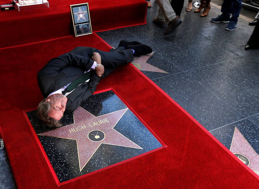 Actor Hugh Laurie poses on his star after it was unveiled on the Hollywood Walk of Fame in Los Angeles, California U.S., October 25, 2016. Reuters/Mario Anzuoni
