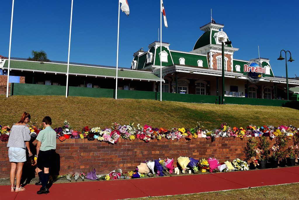Members of the public leave floral tributes outside the main entrance to Dreamworld located on the Gold Coast, Australia October 26, 2016 after Tuesday's tragedy that saw four people killed on the Thunder River Rapids Ride at Australia's biggest theme par