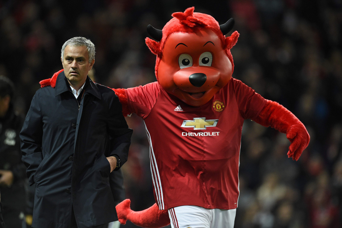 Manchester United's Portuguese manager Jose Mourinho arrives with Fred the Red, United's official mascot, ahead of the EFL (English Football League) Cup fourth round match between Manchester United and Manchester City at Old Trafford in Manchester, north 