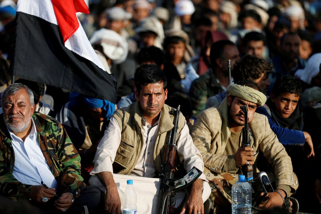 Followers sit along a street as they watch Abdul-Malik al-Houthi, leader of the Houthi movement, deliever a speech on a screen during a rally commemorating the death of Imam Zaid bin Ali in Sanaa, Yemen October 26, 2016. REUTERS/Khaled Abdullah