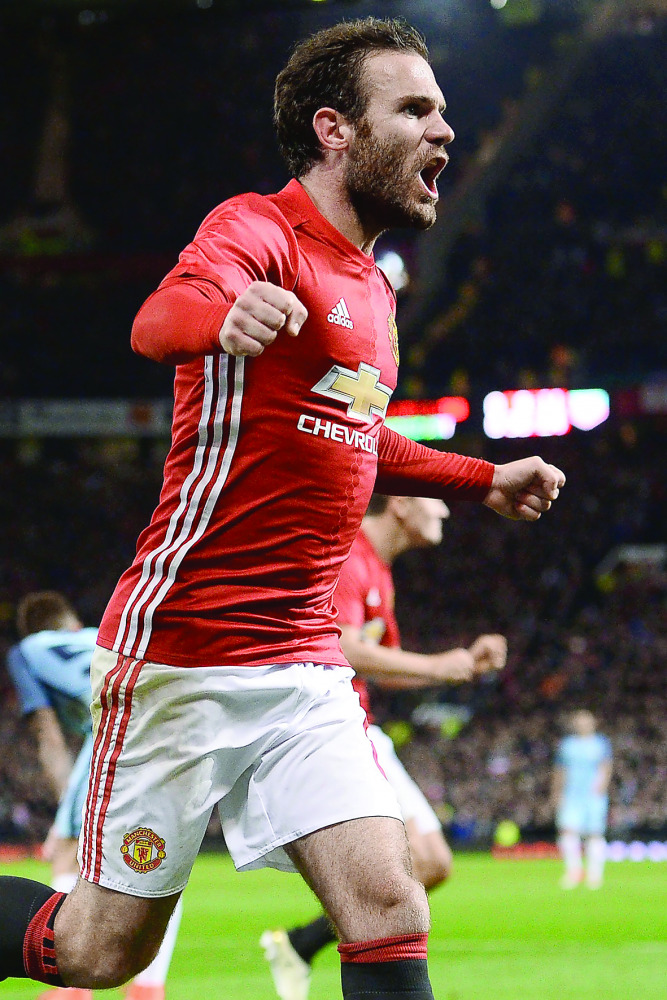 Manchester United’s Spanish midfielder Juan Mata celebrates after scoring a goal against  Manchester City during their English Football League Cup match at Old Trafford in Manchester, England on Wednesday.