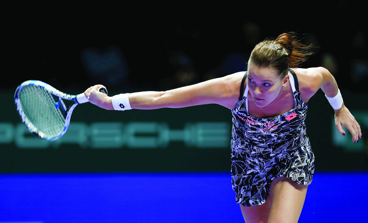 Agnieszka Radwanska of Poland in action against Garbine Muguruza of Spain during the Singapore WTA Finals Round Robin Singles at the Singapore Indoor Stadium yesterday.