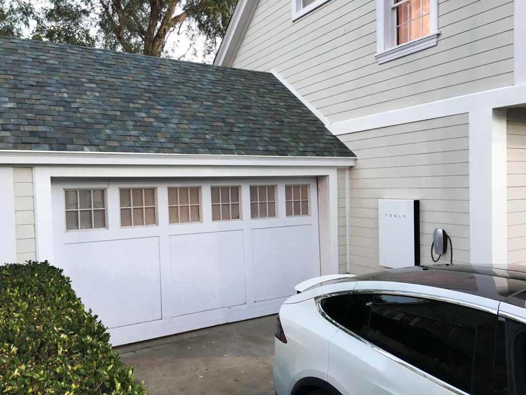 Tesla's electric car, Powerwall and solar roof are shown by Tesla Motors Inc Chief Executive Elon Musk, unveiling new energy products aimed at illustrating the benefits of combining his electric car and battery maker with solar installer SolarCity Corp, i