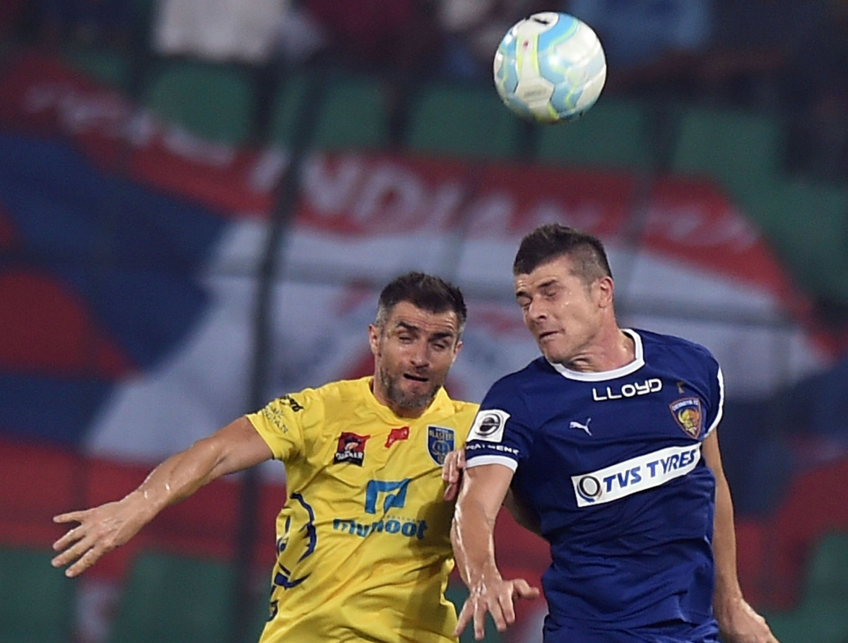 Chennaiyin FC's forward Davide Succi vies for the ball with Kerala Blaster FC's defender Aaron Hughes during the Indian Super League (ISL) football match between Chennaiyin FC and Kerala Blaster FC's at The Jwaharlal Nehru Athletic Stadium in Chennai on O