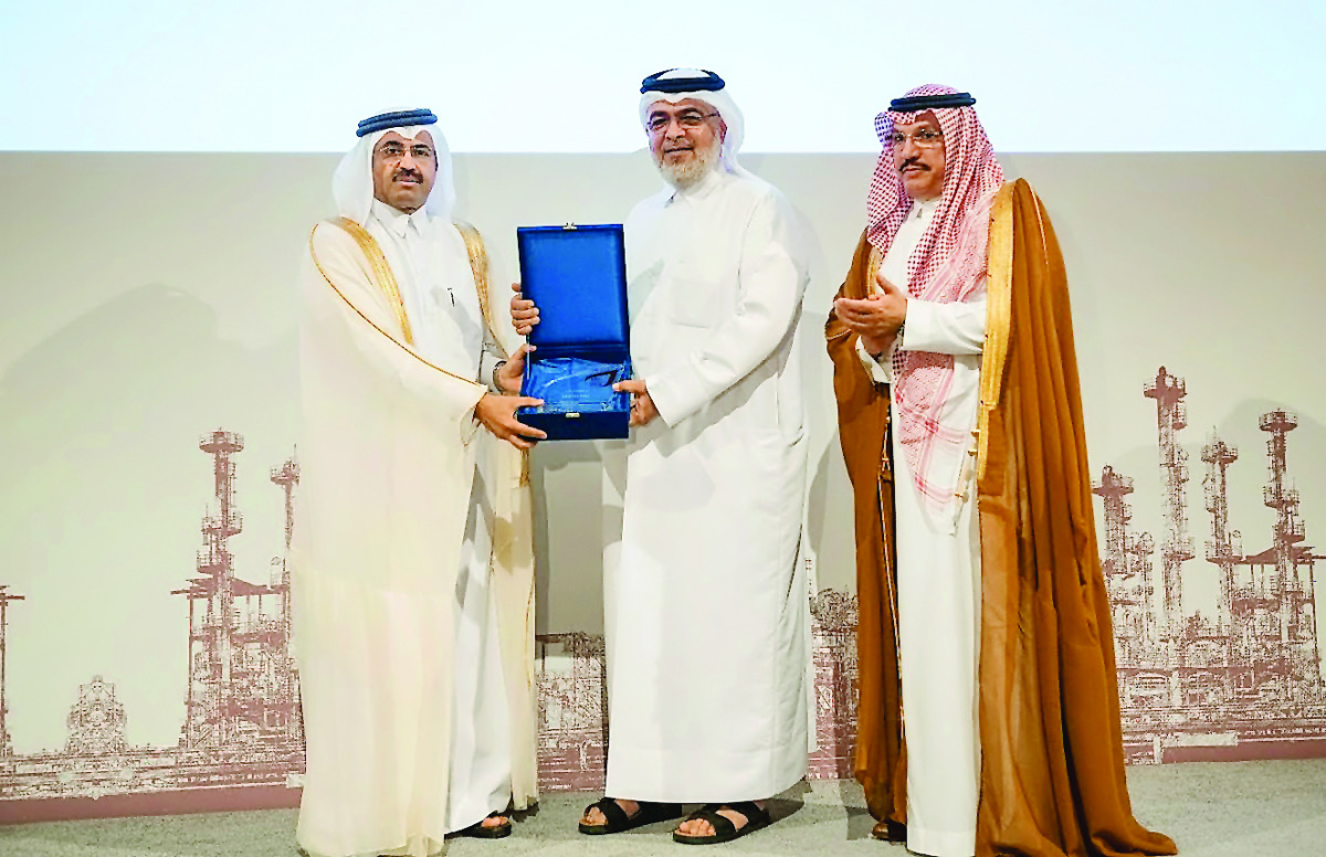 HE Dr. Mohammed bin Saleh Al Sada, Minister of Energy and Industry giving away an award to Mohamed Al Mushiri, ORYX GTL Chief Commercial Officer at the event yesterday; while Abdulaziz bin Hamad Al Ageel looks on. Pic: Baher Amin / The Peninsula