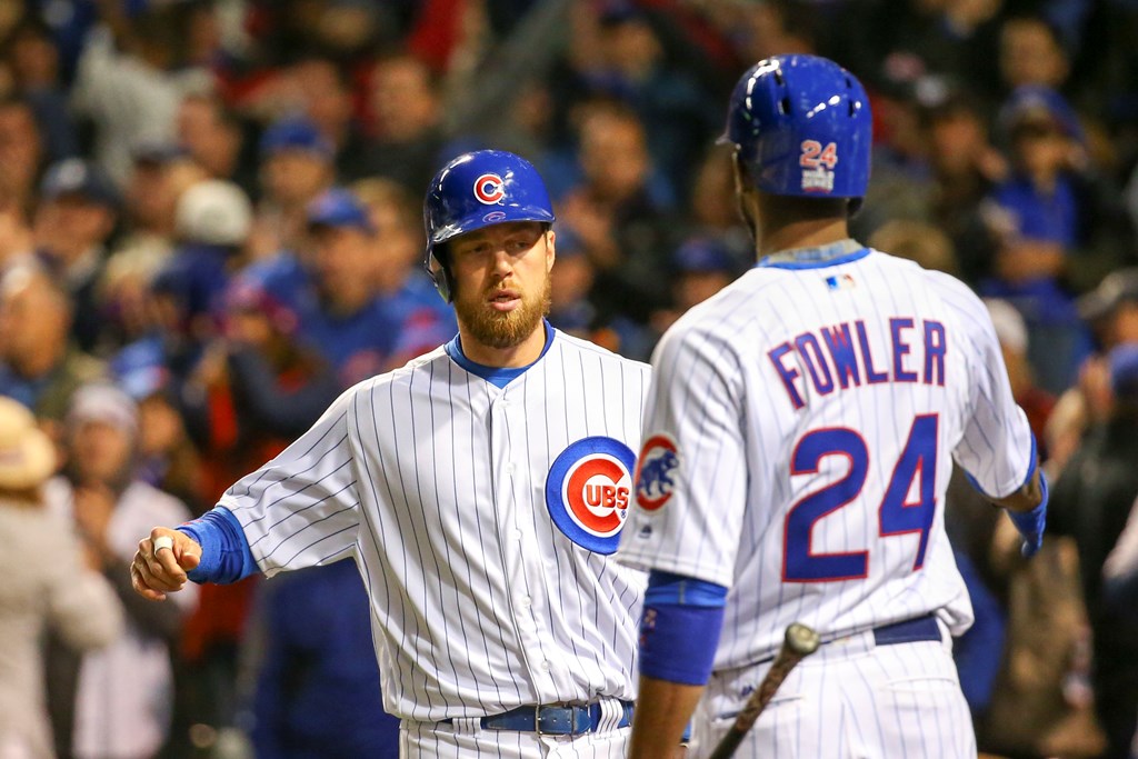 Chicago Cubs left fielder Ben Zobrist (left) is congratulated by center fielder Dexter Fowler (24) for scoring on a sacrifice fly by catcher David Ross (not pictured) against the Cleveland Indians during the fourth inning in game five of the 2016 World Se