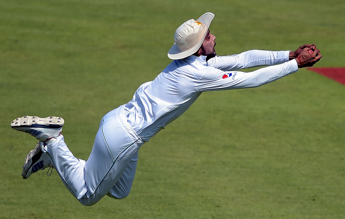 Pakistani cricketer Mohammad Amir takes a catch of West Indies' batsman Darren Bravo (unseen) on the second day of the third and final Test between Pakistan and West Indies at the Sharjah Cricket Stadium in Sharjah on October 31, 2016. (AFP / Aamir QURESH