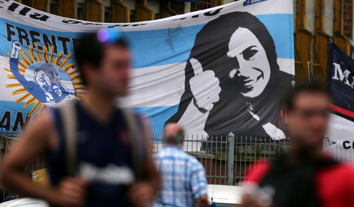 Supporters of former Argentine President Cristina Fernandez de Kirchner stand in front of a banner with her image as they wait for her to leave court in Buenos Aires, Argentina, October31, 2016. REUTERS/Marcos Brindicci