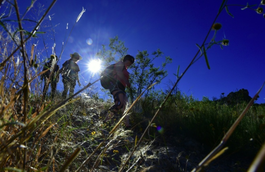 Volunteers hike into the borderlands of Arizona, and leave water behind for migrants as many die of dehydration or, in winter, hypothermia | © AFP/File | Frederic J. Brown