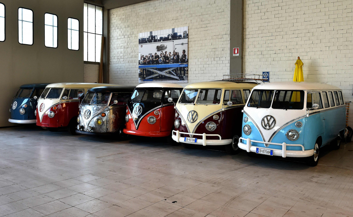 Vintage Volkswagen Kombi bus (van, transporter or camper) are parked in a garage after being completly restored by mechanics of the 