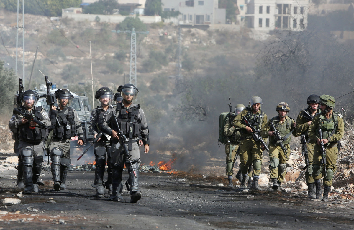 Israeli security forces take position during clashes with Palestinian protesters following a demonstration against the expropriation of Palestinian land by Israel on Nonvember 4, 2016, in the village of Kfar Qaddum, near Nablus, in the occupied West Bank.