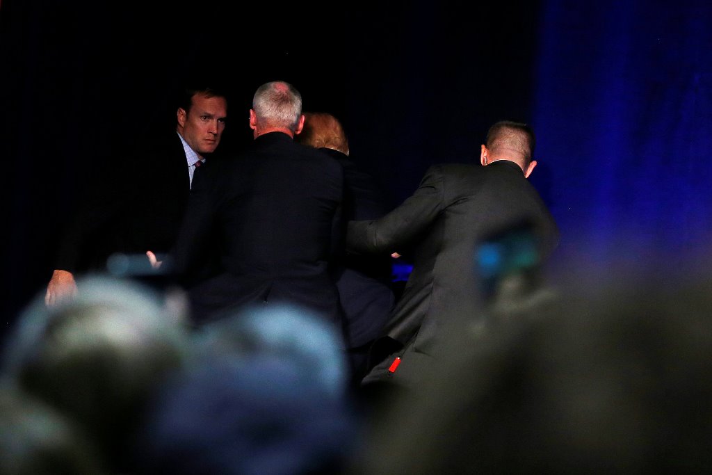 Republican presidential nominee Donald Trump is hustled off the stage by security agents during an incident at a campaign rally in Reno, Nevada, U.S. November 5, 2016. REUTERS/Carlo Allegri
