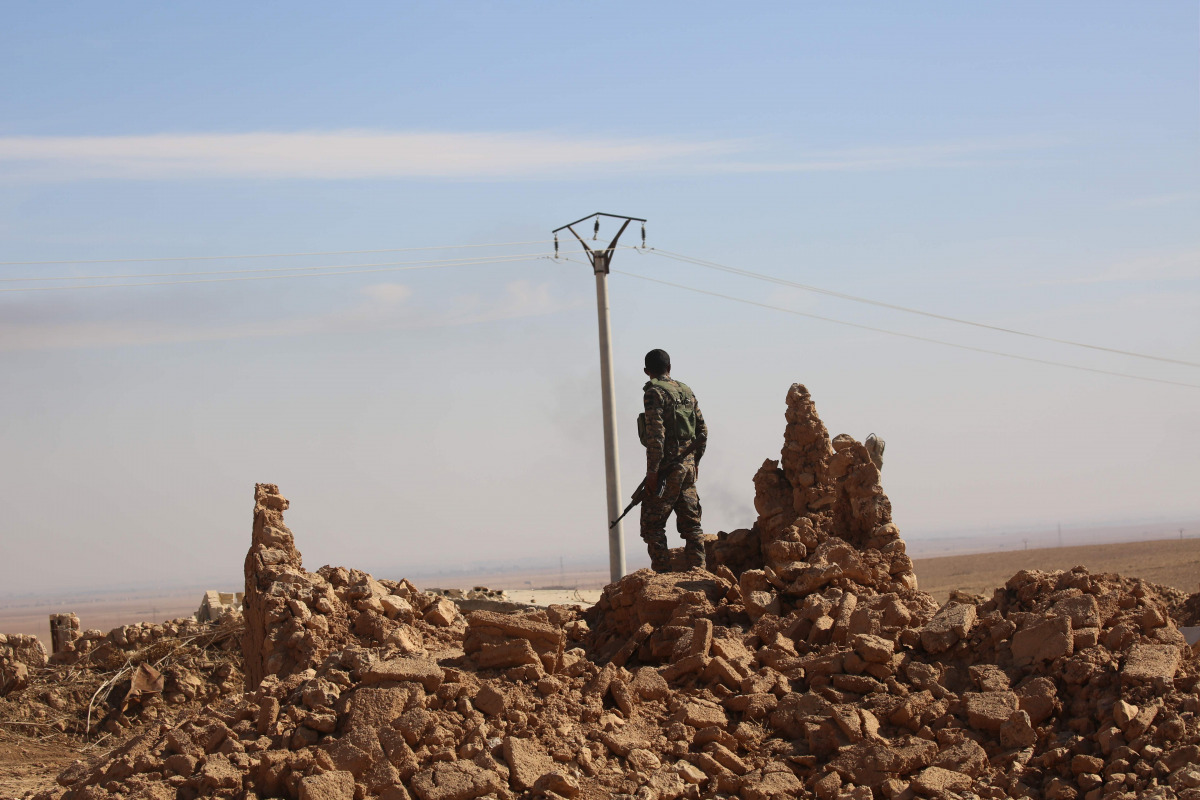A member of the Syrian Democratic Forces (SDF), a US-backed Kurdish-Arab alliance, patrols in the village of Tal Aaj, 5 kilometre from the Syrian town of Ain Issa, some 50 kilometres (30 miles) north of Raqa, on November 7, 2016, as they launched an offen