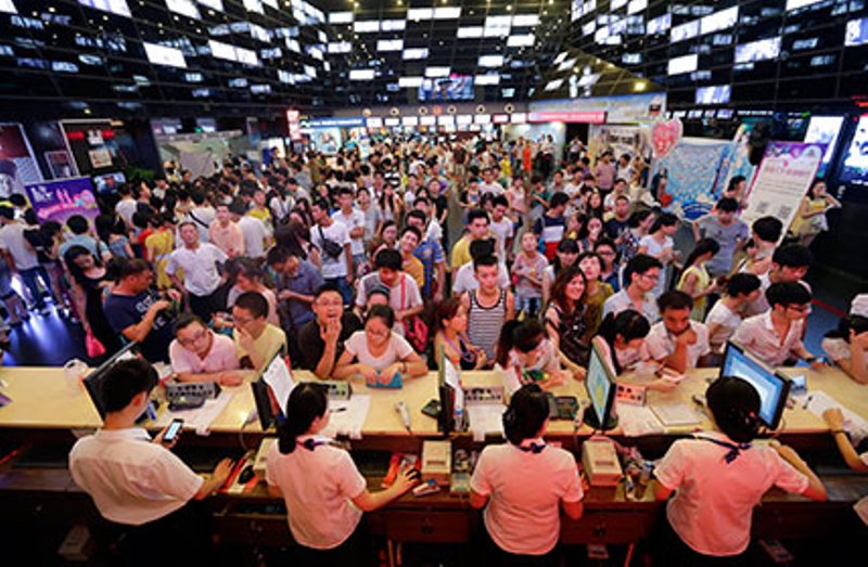 A file photo of people waiting for tickets at a movie theater in Wuhan, China. Reuters 