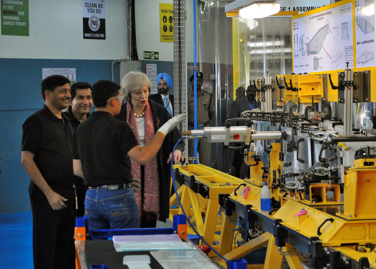 Britain's Prime Minister Theresa May speaks with the employees during her visit to a Dynamatic Technologies Limited facility in Bengaluru, India November 8, 2016. REUTERS/Abhishek N. Chinnappa