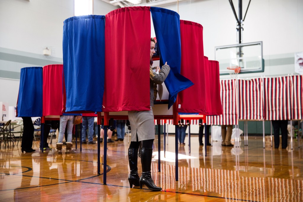 New Hampshire citizens cast their vote at Amherst Street Elementary School on November 8, 2016, in Nashua, New Hampshire. Americans today will choose between Republican presidential candidate Donald Trump and Democratic presidential candidate Hillary Clin