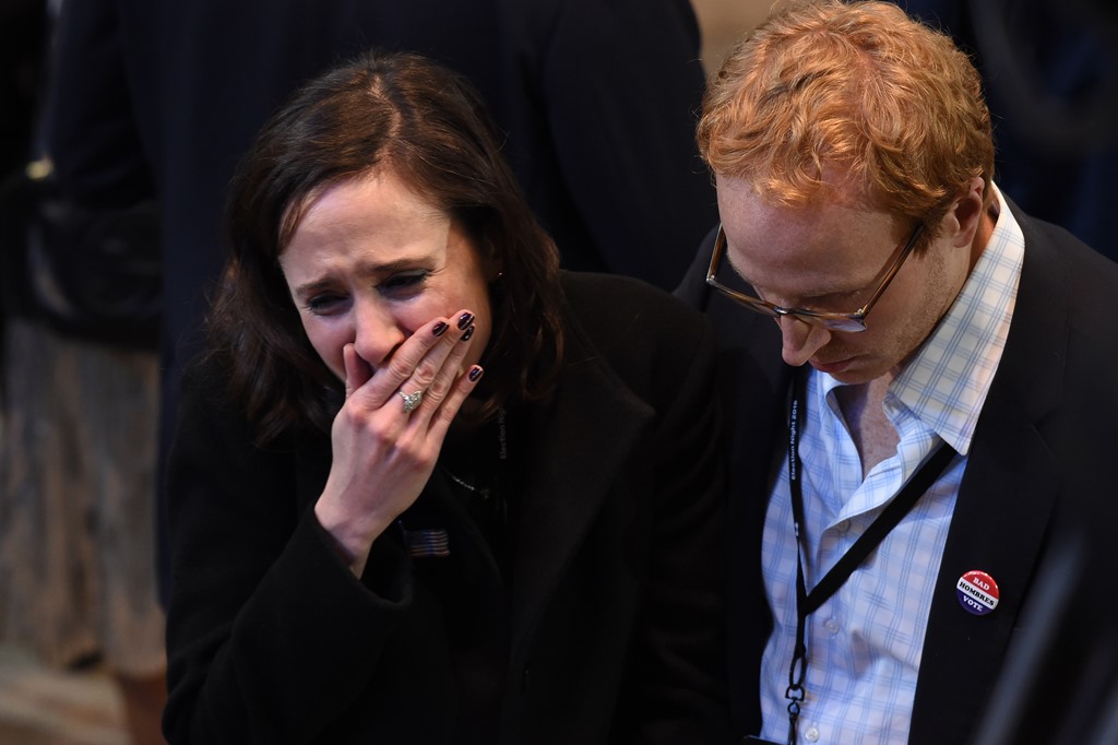 Supporter of Democratic presidential nominee Hillary Clinton react to television reports during election night at the Jacob K Javits Convention Center in New York on November 8, 2016. AFP / Robyn BECK